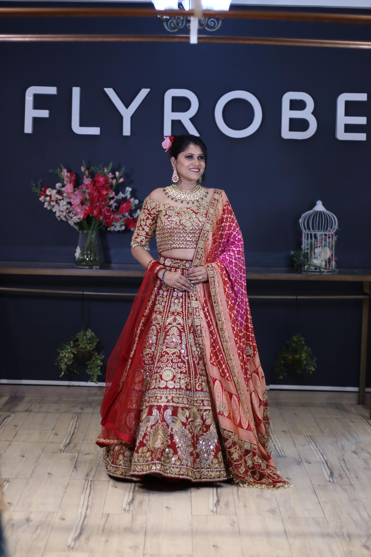 Photo of bride wearing a regal red and gold lehenga
